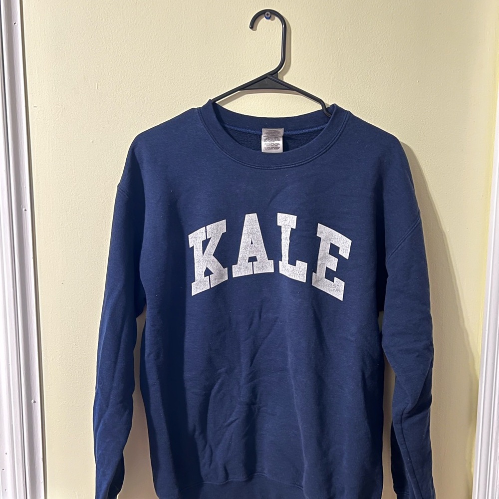 Custom Printed Navy Blue Crewneck Sweater with “KALE” on the front.